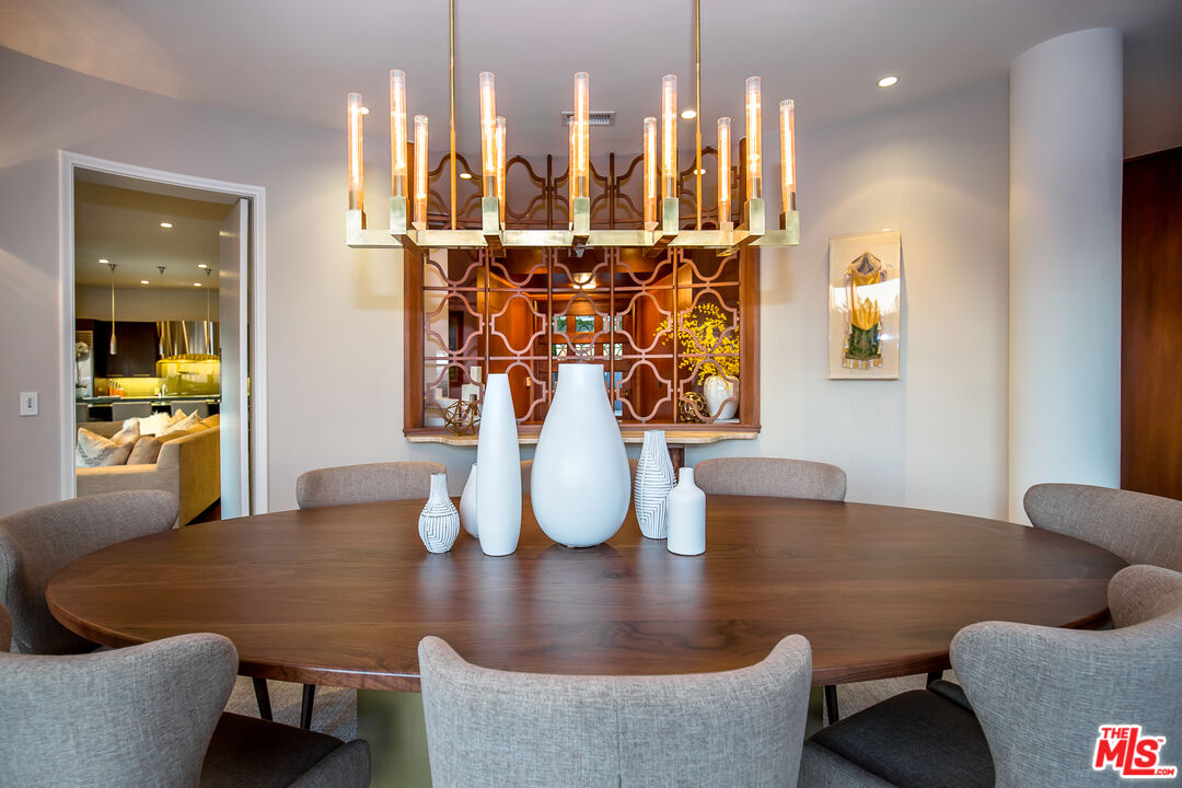 1131 Miradero Road Beverly Hills, CA 90210 - Photo 9 of 42 a dining room with furniture and wooden floor