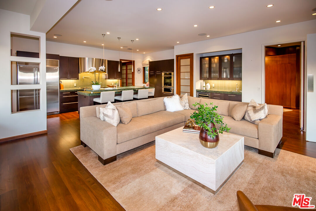 1131 Miradero Road Beverly Hills, CA 90210 - Photo 10 of 42 a living room with furniture and wooden floor