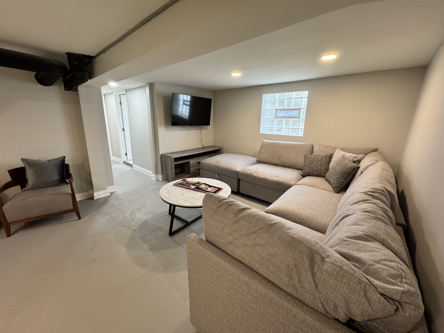 822 East 87th Place Chicago, IL 60619 - Photo 22 of 31 a living room with furniture and a flat screen tv
