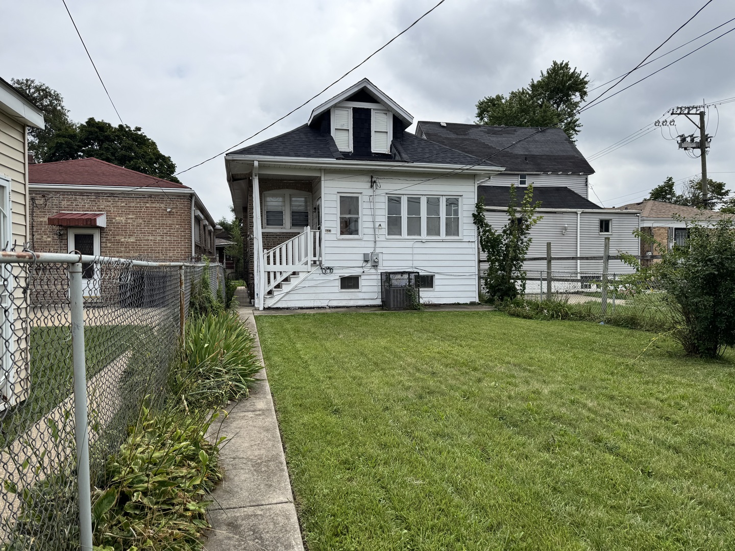 822 East 87th Place Chicago, IL 60619 - Photo 26 of 31 a front view of a house with a yard