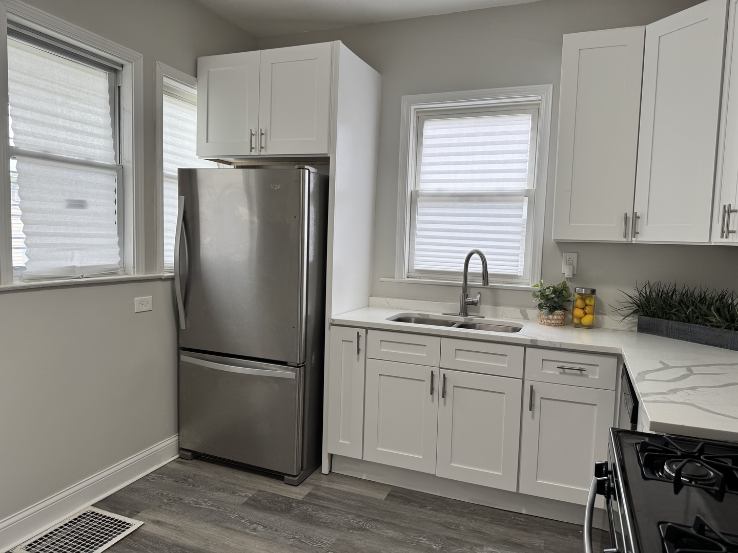 822 East 87th Place Chicago, IL 60619 - Photo 8 of 31 a kitchen with appliances a sink cabinets and a window