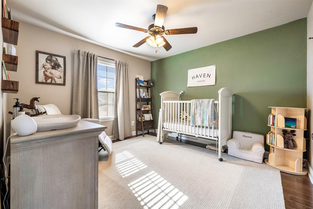 9142 Parkview Circle Tolar, TX 76476 - Photo 18 of 31 a spacious bedroom with a bed and a chandelier