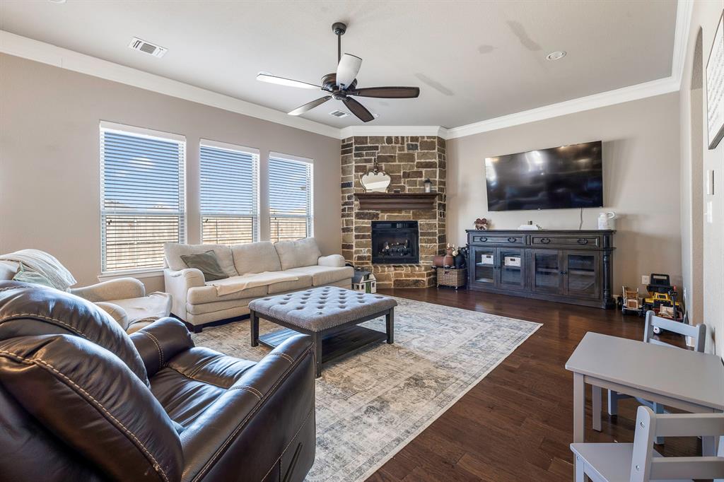 9142 Parkview Circle Tolar, TX 76476 - Photo 30 of 31 a living room with furniture a flat screen tv and a fireplace