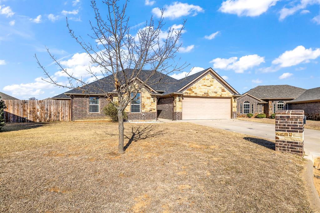 9142 Parkview Circle Tolar, TX 76476 - Photo 3 of 31 a house with yard and parking space