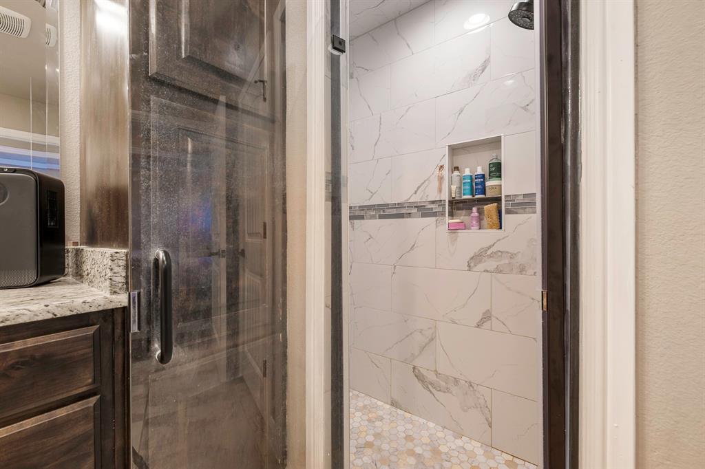 9142 Parkview Circle Tolar, TX 76476 - Photo 9 of 31 a bathroom with a granite countertop shower a sink and a mirror