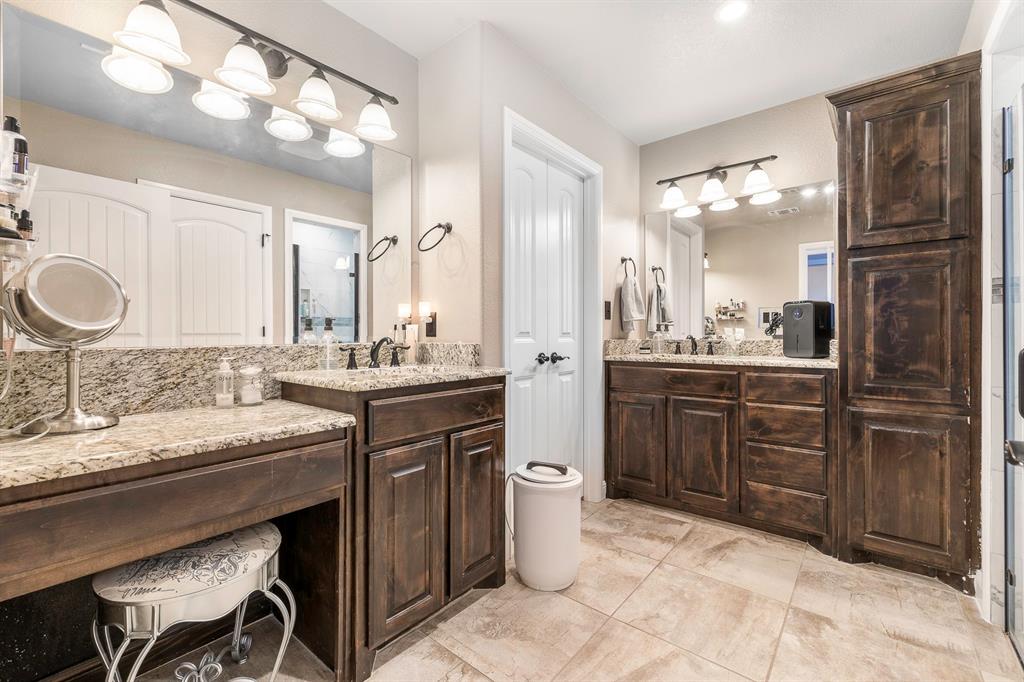 9142 Parkview Circle Tolar, TX 76476 - Photo 10 of 31 a bathroom with a granite countertop sink a toilet and a mirror