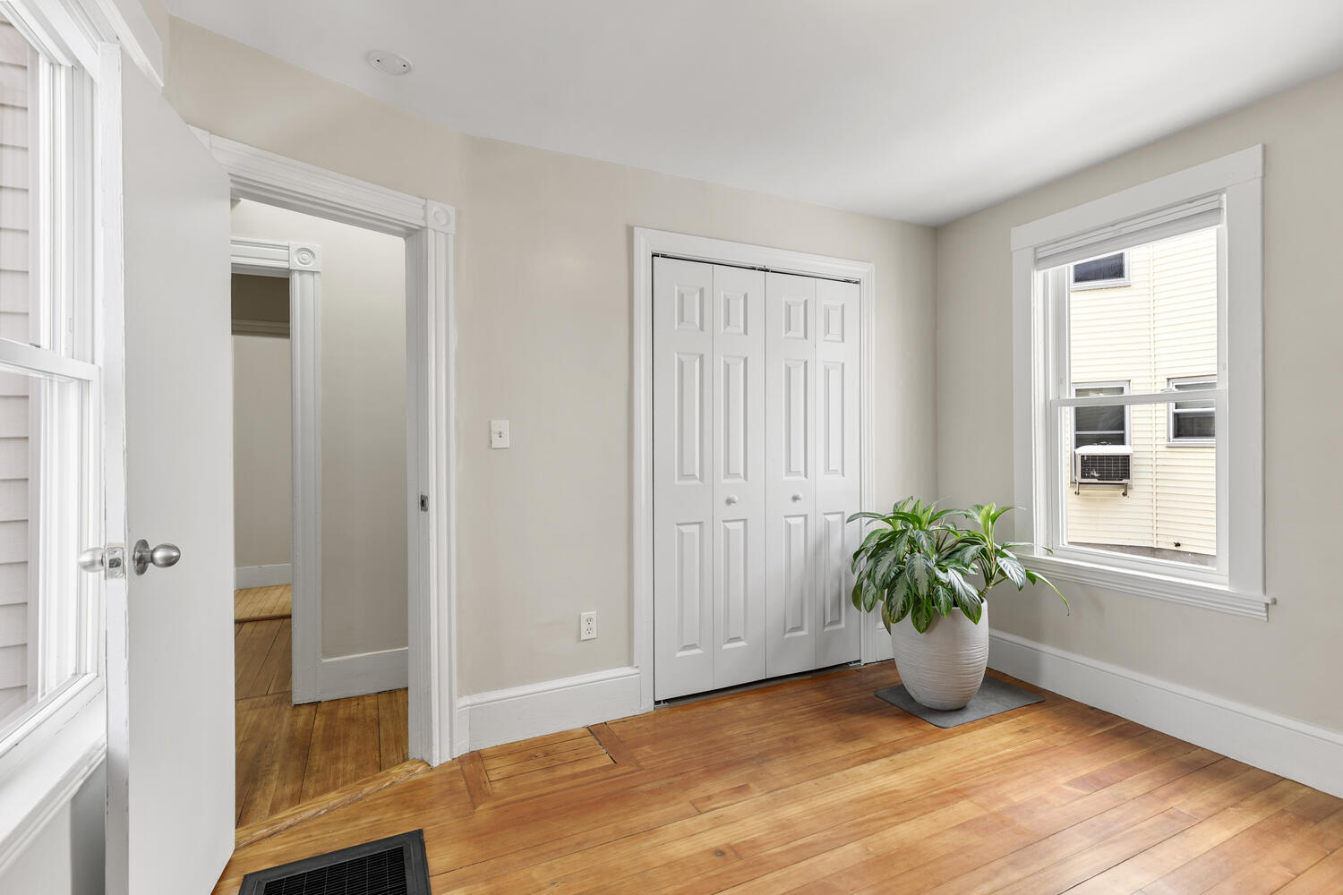 20 Fairmount Street Everett, MA 02149 - Photo 12 of 53 an empty room with wooden floor and windows