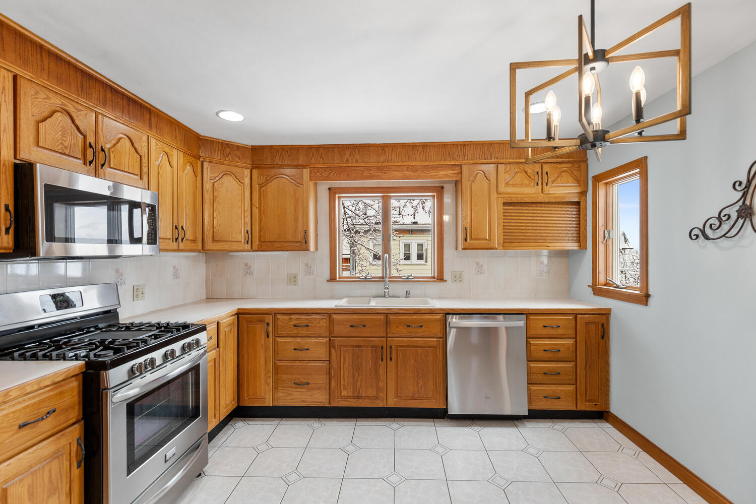 20 Fairmount Street Everett, MA 02149 - Photo 25 of 53 a kitchen with stainless steel appliances granite countertop a stove a sink and a microwave