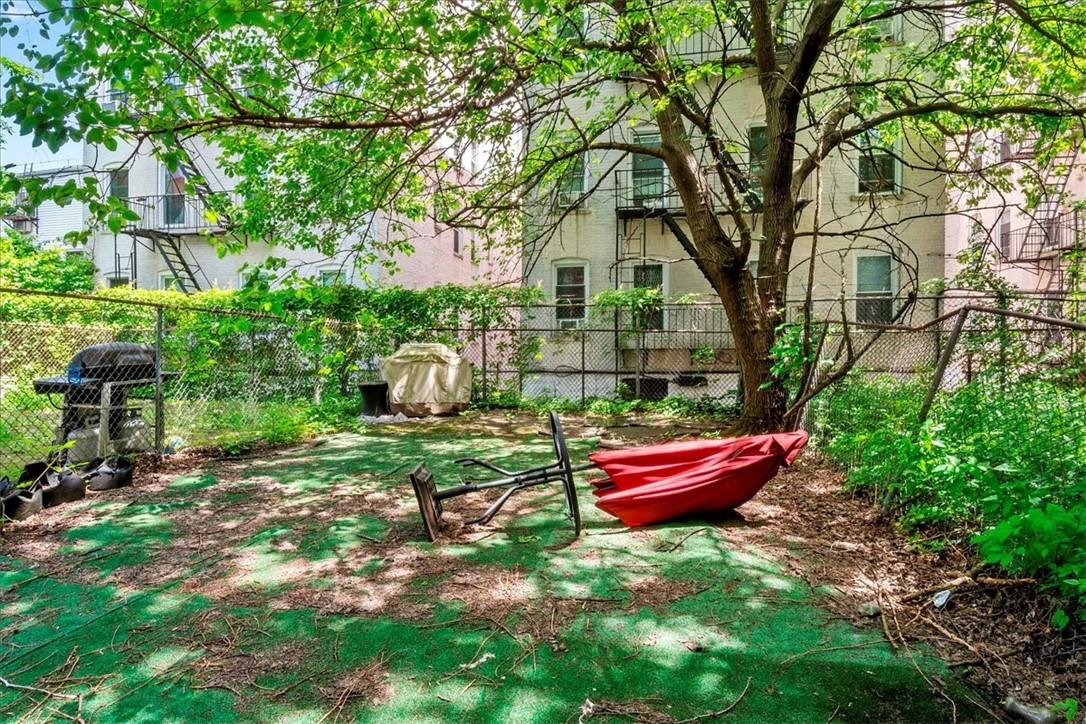 1012 Faile Street, Unit 1012A Bronx, NY 10459 - Photo 19 of 20 a backyard of a house with a yard and outdoor seating