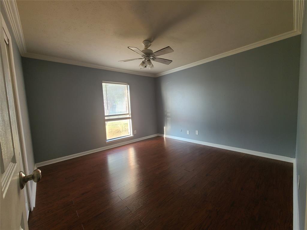 5644 Perrin Street The Colony, TX 75056 - Photo 9 of 16 Unfurnished room featuring ornamental molding, ceiling fan, and dark hardwood / wood-style floors