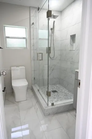 a bathroom with a shower and toilet