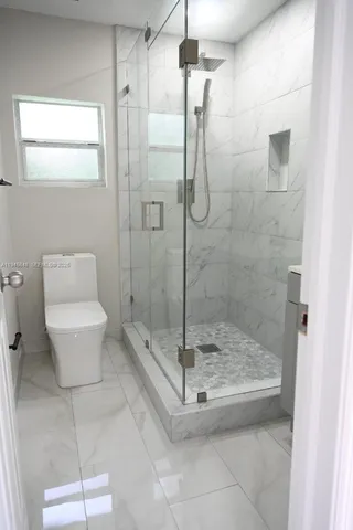 a bathroom with a shower and toilet