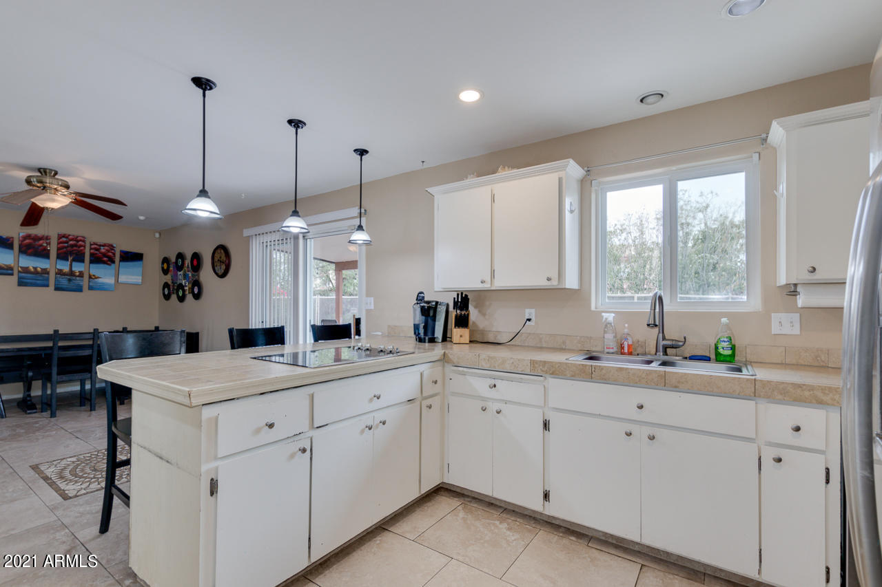 4215 West Dailey Street Phoenix, AZ 85053 - Photo 14 of 32 a kitchen with a sink window and cabinets