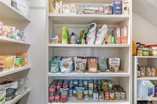 a utility room with lots of clutter and washer