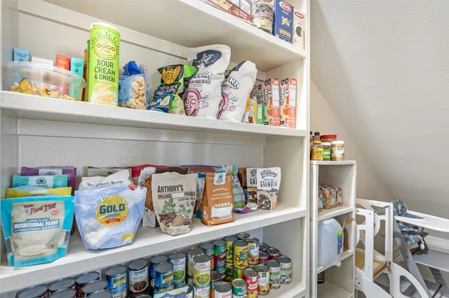 a view of a livingroom with wooden floor and stairs