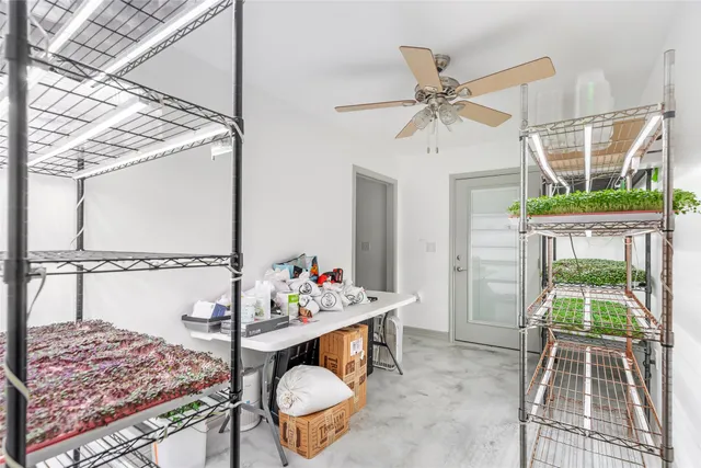 a spacious bedroom with a bed and a ceiling fan