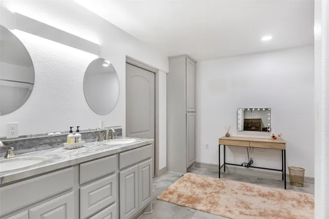 a view of a double sink and a mirror