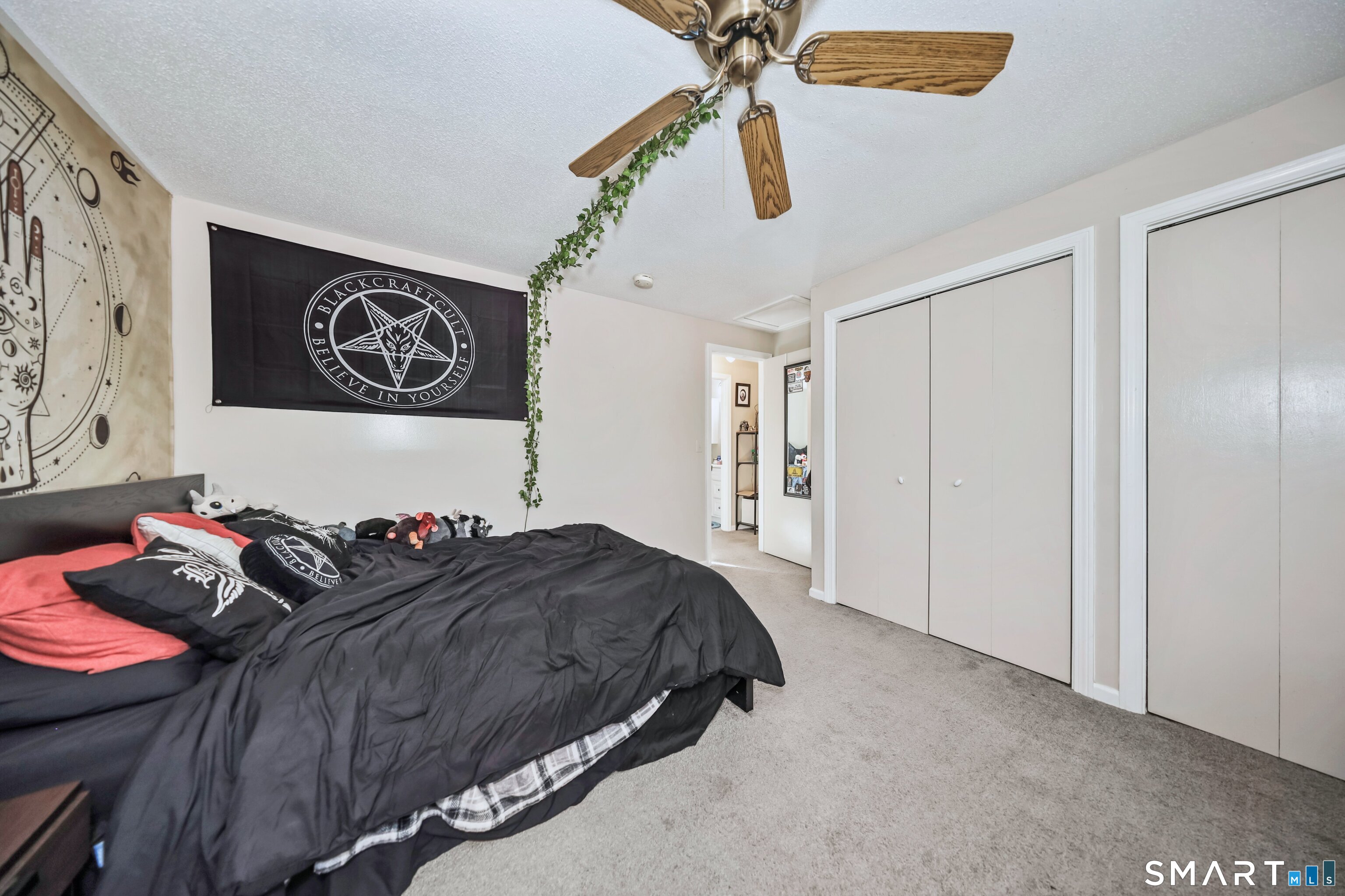349 Allen Road, Unit 34C Torrington, CT 06790 - Photo 18 of 31 a bedroom with a bed and a chandelier
