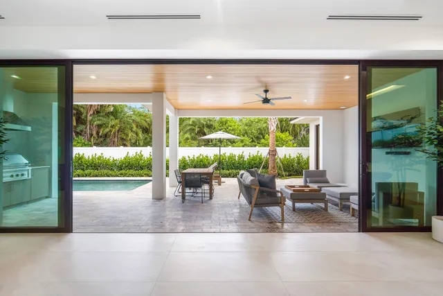 a view of a porch with chairs and backyard