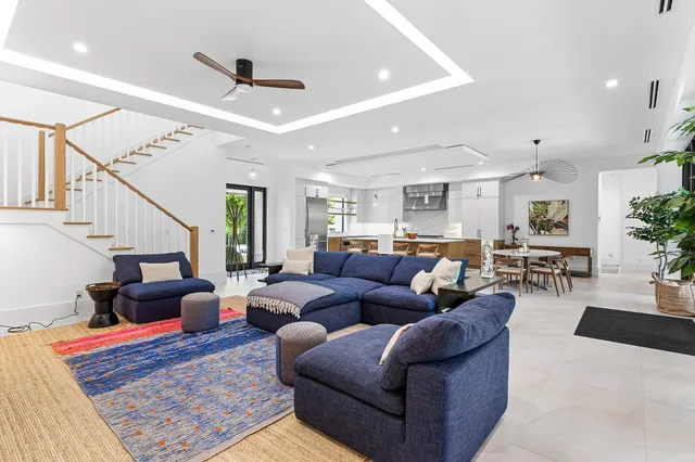 a living room with furniture ceiling fan and a rug