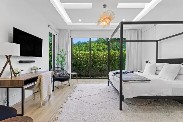 a bedroom with a bed and large window