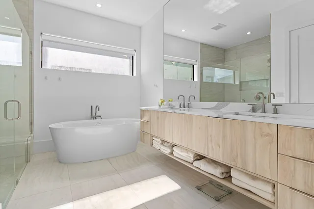 a bathroom with a tub sink and mirror