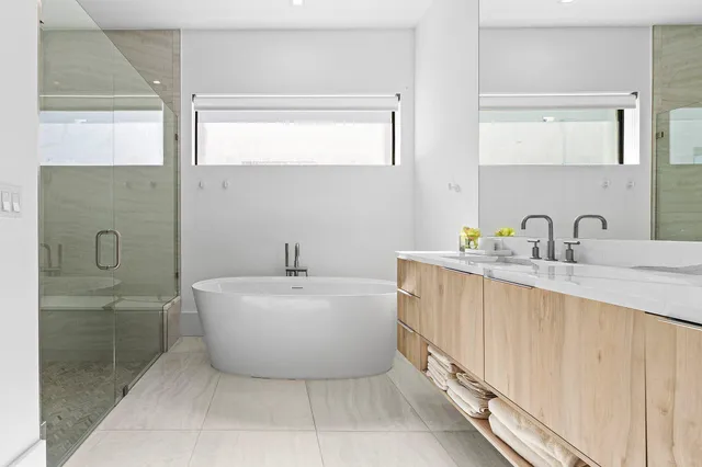 a spacious bathroom with a bathtub and mirror