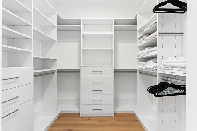 a view of walk in closet with empty racks