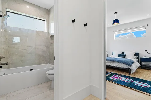 a bathroom with a tub and a view of bathroom