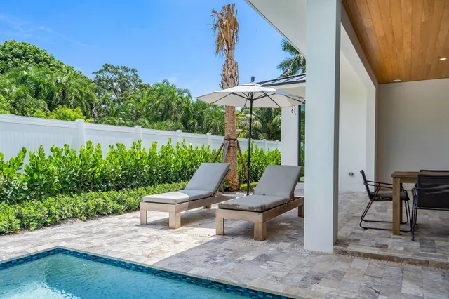 a view of a patio with table and chairs potted plants with wooden fence