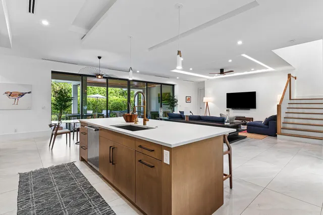 a large white kitchen with a large window