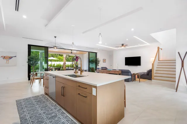 a large white kitchen with a large window