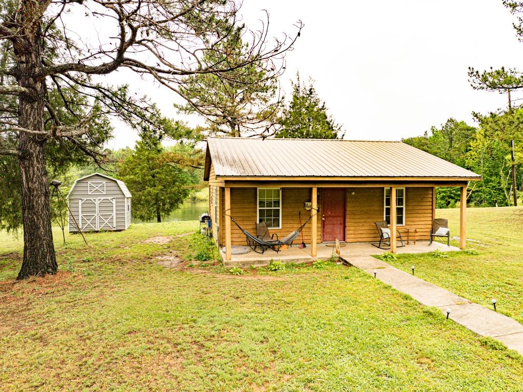 0 Poplar Grove Cemetery Road Henning, TN 38041 - Photo 3 of 40 Wood-sided residence with a metal roof and covered front porch