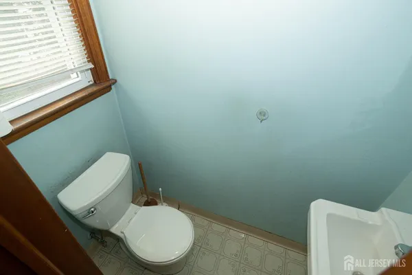 a white toilet sitting next to a window