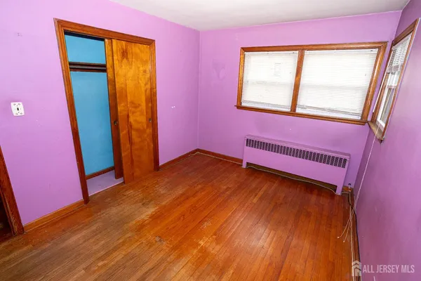 a view of a room with wooden floor and a window
