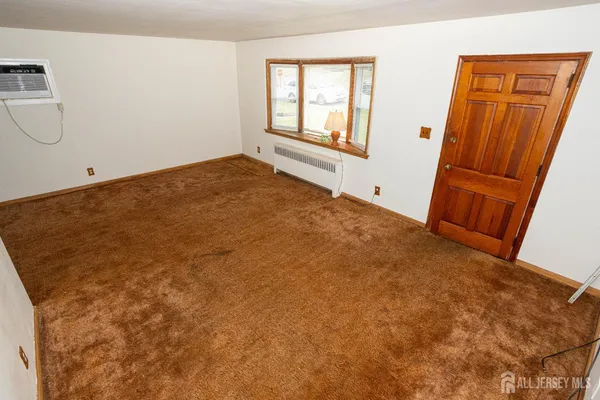 a view of an empty room and a window