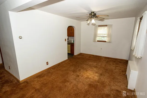 a view of a bedroom with window and ceiling fan