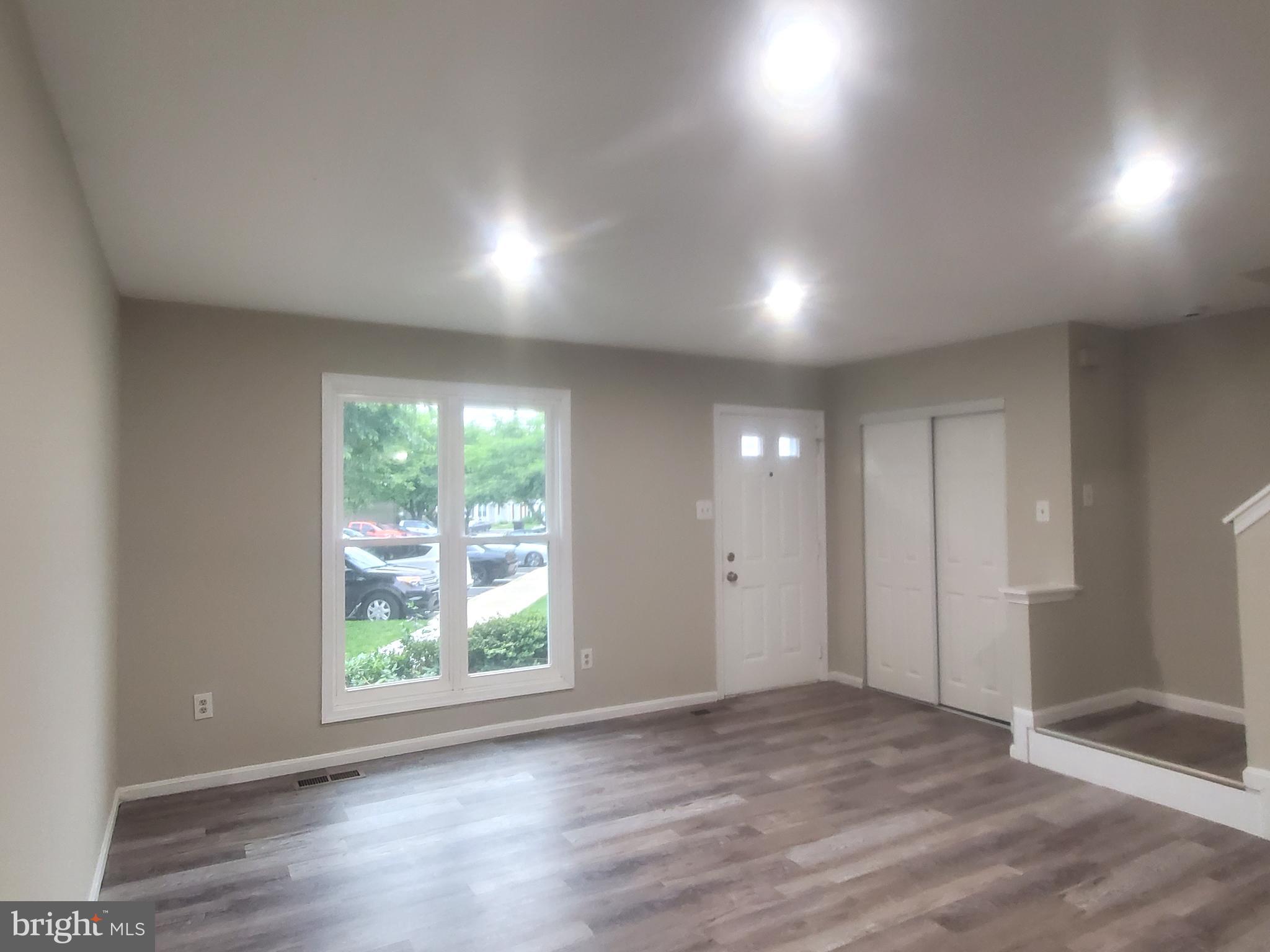 14813 Hammersmith Circle Silver Spring, MD 20906 - Photo 5 of 36 an empty room with wooden floor and windows