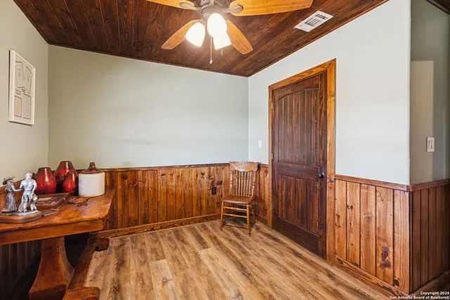 a kitchen with stainless steel appliances granite countertop a refrigerator a sink dishwasher a stove with wooden cabinets and floor