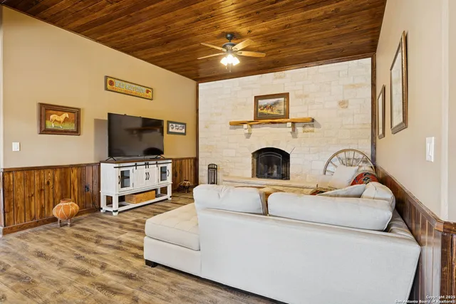 a kitchen with a sink wooden cabinets and a window