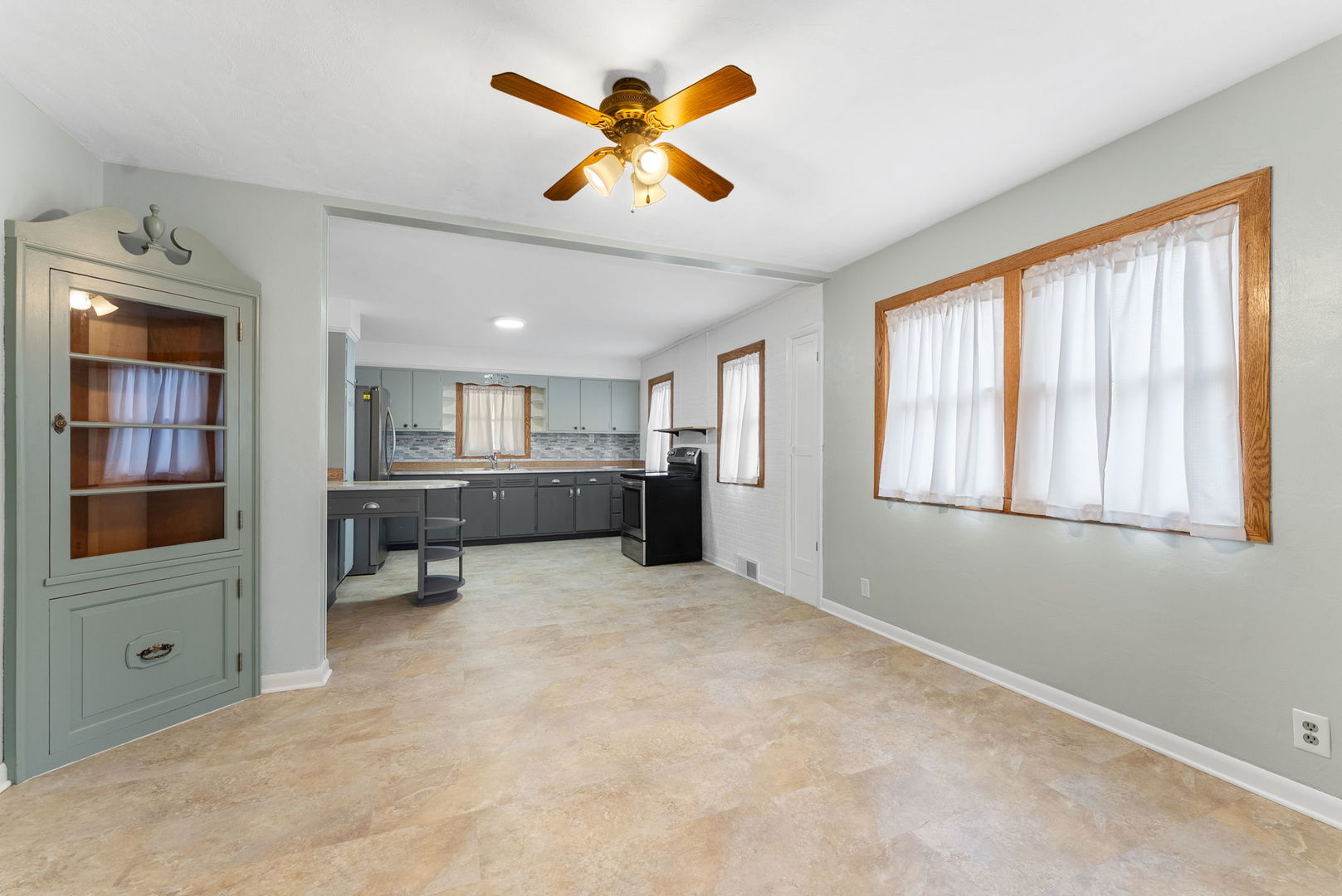 1419 113th Avenue Milan, IL 61264 - Photo 11 of 25 an empty room with chandelier fan and windows