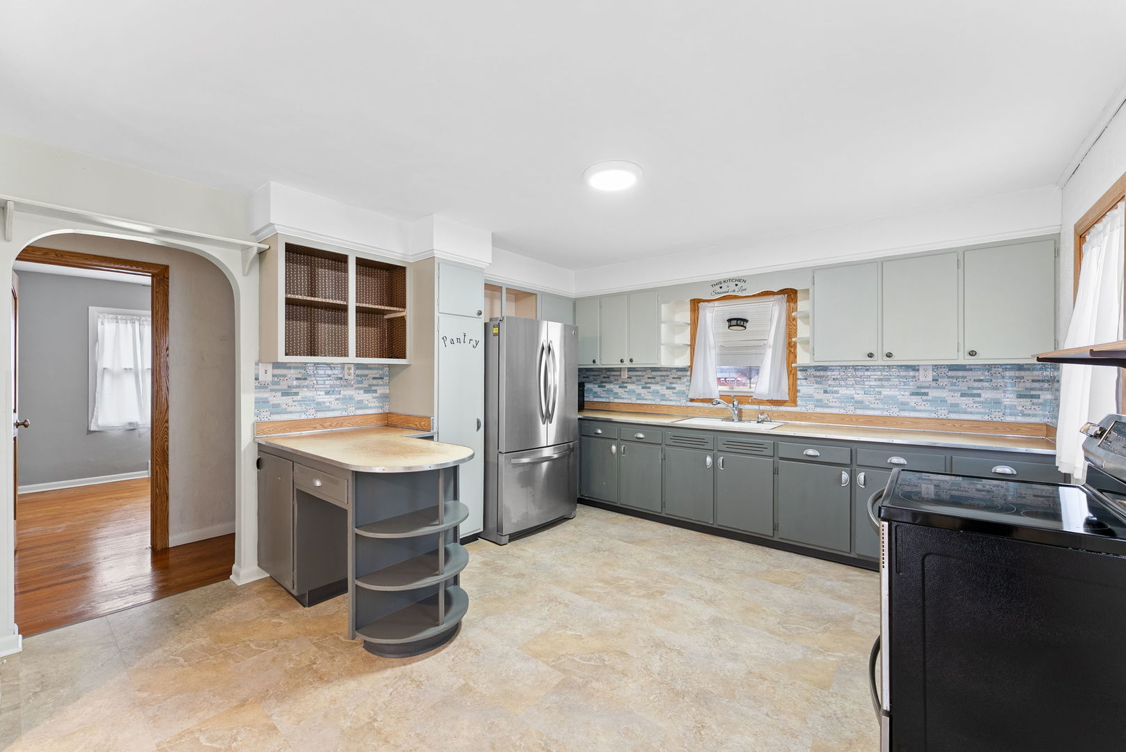 1419 113th Avenue Milan, IL 61264 - Photo 12 of 25 a kitchen with a sink stove and refrigerator