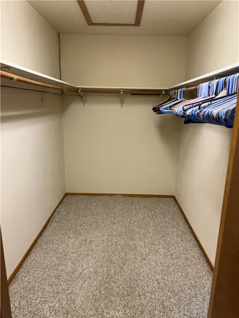 a view of a room with an empty space and a window