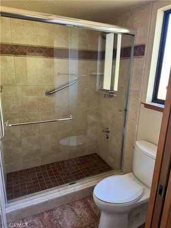 a bathroom with a toilet and a shower