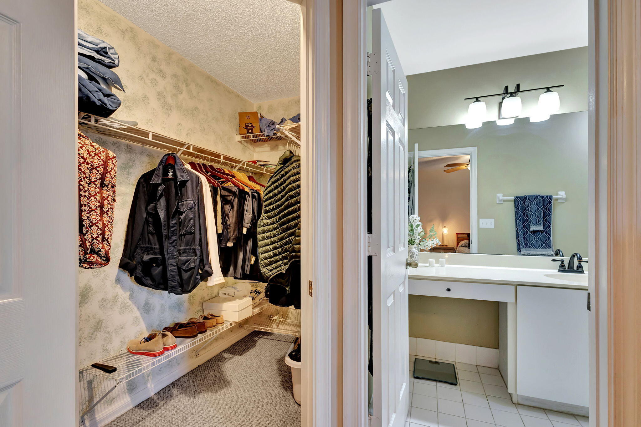 145 Timberwalk Trail Jupiter, FL 33458 - Photo 25 of 61 a view of walk in closet with clothes and shoes