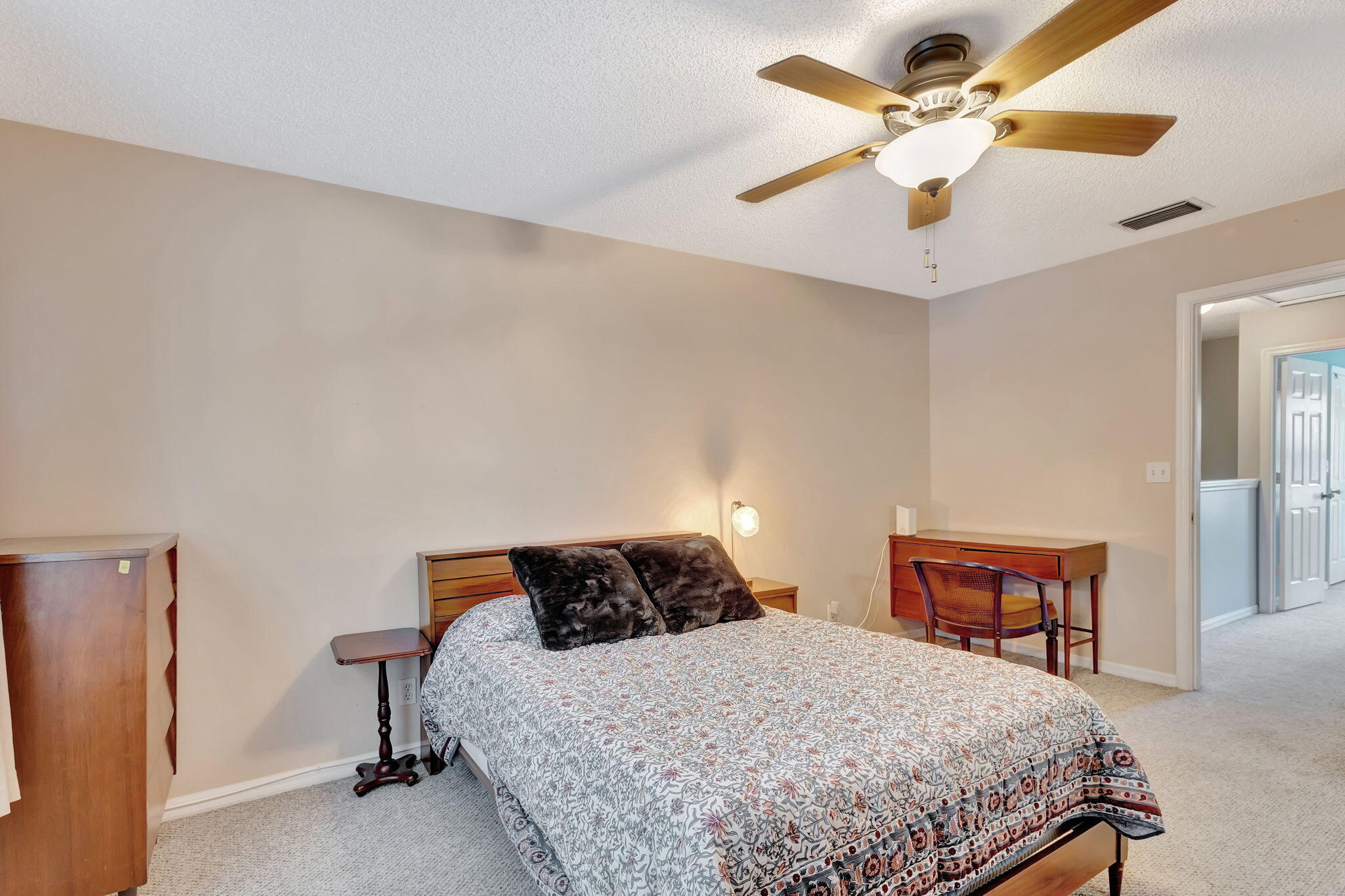 145 Timberwalk Trail Jupiter, FL 33458 - Photo 27 of 61 a bedroom with a bed and a chandelier