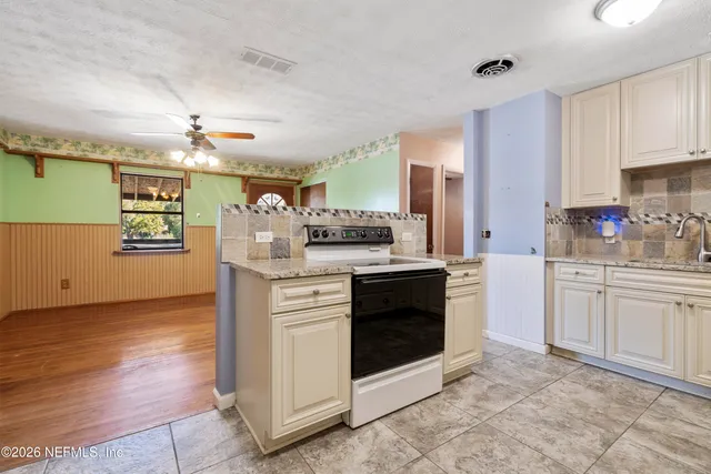 a kitchen with stainless steel appliances granite countertop a stove and a sink