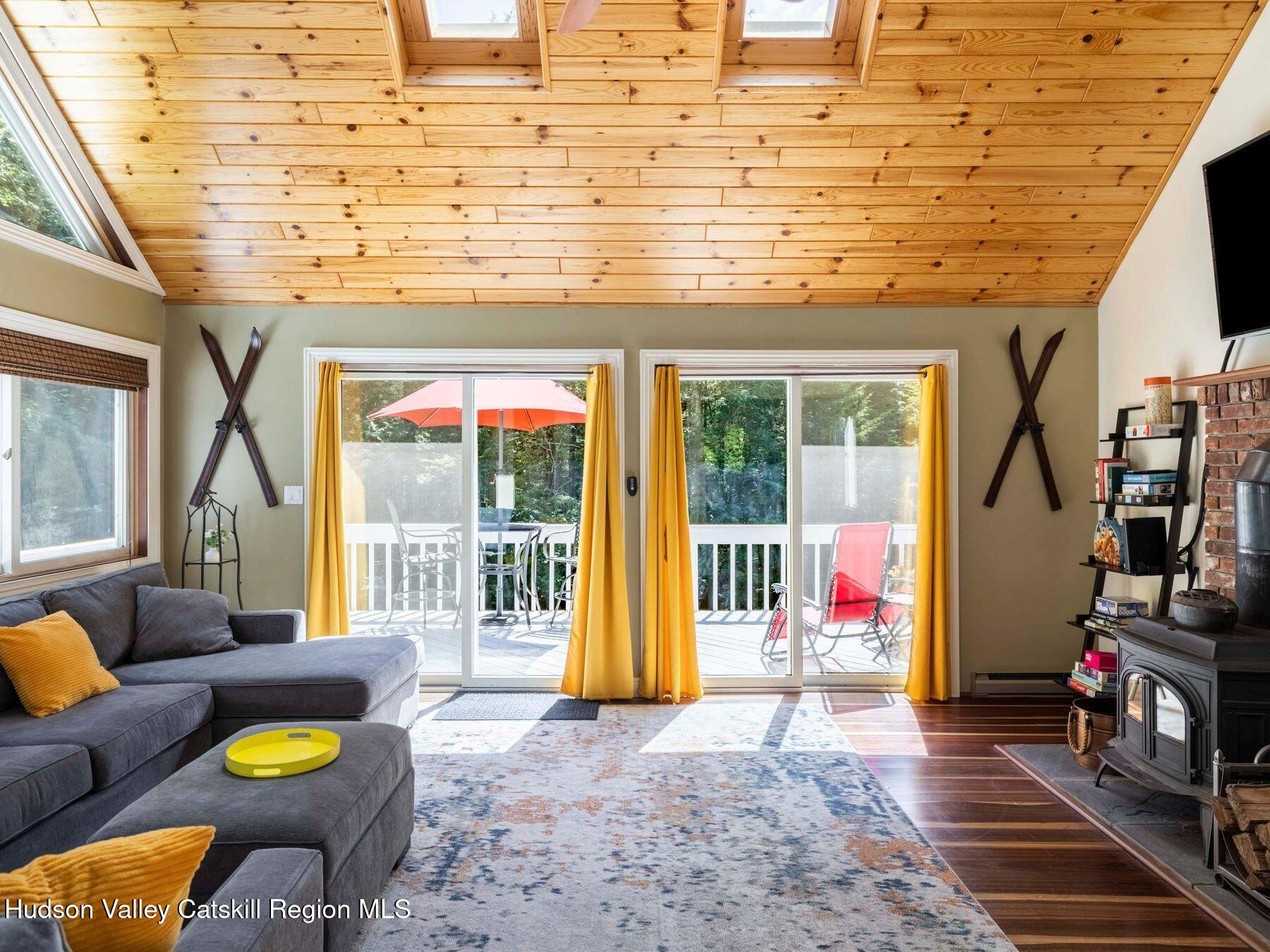 36 Mt Greenery Road Windham, NY 12496 - Photo 11 of 60 a living room with patio furniture and floor to ceiling windows