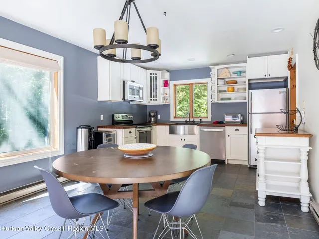 a kitchen with stainless steel appliances granite countertop white cabinets and a stove a oven with white countertops