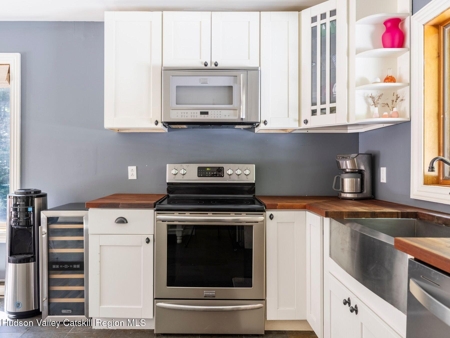 36 Mt Greenery Road Windham, NY 12496 - Photo 20 of 60 a kitchen with stainless steel appliances granite countertop white cabinets and a stove a oven with white countertops